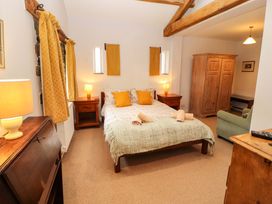 A bedroom with a bed and wardrobe at Two Town End, Mungrisdale, Mosedale