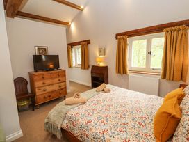 A bedroom with a bed and television at Two Town End in Mungrisdale, Mosedale