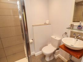 A bathroom with a shower, toilet, and sink at Two Town End in Mungrisdale, Mosedale