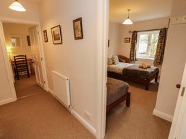 A bedroom with two beds and a window at Two Town End in Mungrisdale, Mosedale