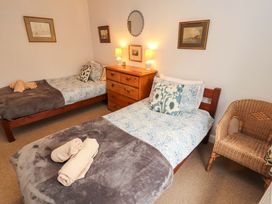 A bedroom with two beds and a chest of drawers at Two Town End in Mungrisdale, Mosedale