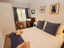 A bedroom with a bed and a chair at Two Town End in Mungrisdale, Mosedale