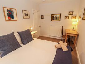 A bedroom with a bed and desk at Two Town End in Mungrisdale, Mosedale
