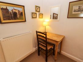 A study room with a desk and lamp at Two Town End in Mungrisdale, Mosedale