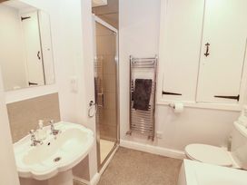 A bathroom with a sink, shower, and toilet at Two Town End, Mungrisdale, Mosedale