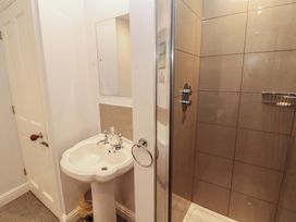 A bathroom featuring a sink, mirror, shower and toilet at Two Town End, Mungrisdale, Mosedale