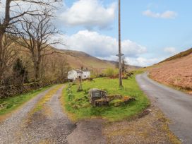 A road with a house and sign at Town End in Mungrisdale, Mosedale