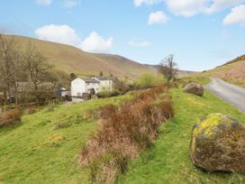 A rural landscape with houses and a road at Two Town End in Mungrisdale, Mosedale