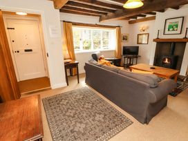 A living room with a sofa and fireplace at Two Town End in Mungrisdale, Mosedale