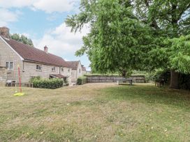 A yard with a house and trees at The Stable House in Sherborne