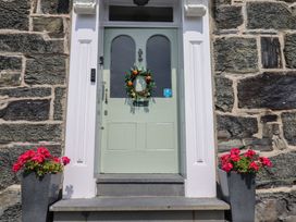 An entrance with a door and flower planters at 5 Porkington Terrace Barmouth