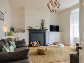 A living room with a sofa and television at 5 Porkington Terrace in Barmouth