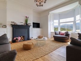 A living room with a fireplace and television at 5 Porkington Terrace in Barmouth