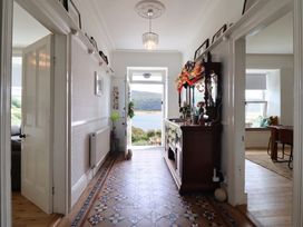 A hallway with a decorative console table and a view of the outdoors at 5 Porkington Terrace in Barmouth