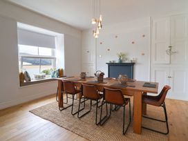 A dining room with a table and chairs at 5 Porkington Terrace Barmouth