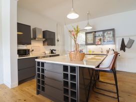 A kitchen with cabinets and a central island at 5 Porkington Terrace Barmouth