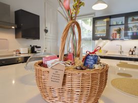 A basket with chocolates and Welsh cakes in a kitchen at 5 Porkington Terrace Barmouth