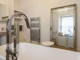A bathroom with a bathtub and sink at 5 Porkington Terrace in Barmouth