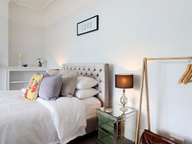 A bedroom with a bed and side table at 5 Porkington Terrace in Barmouth