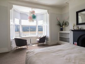 A bedroom with a view of a river at 5 Porkington Terrace Barmouth