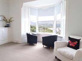 A living room with chairs and a window view at 5 Porkington Terrace in Barmouth