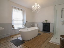 A bathroom with a bathtub and shower at 5 Porkington Terrace in Barmouth