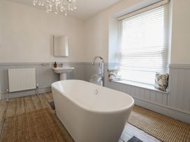 A bathroom with a bathtub and sink at 5 Porkington Terrace in Barmouth