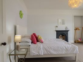 A bedroom with a bed and lamp at 5 Porkington Terrace in Barmouth