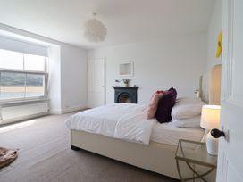 A bedroom with a bed and lamp at 5 Porkington Terrace in Barmouth