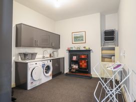 A laundry room with washing machine and dryer at 5 Porkington Terrace Barmouth