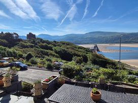 A view of a river and bridge with mountains in the background at 5 Porkington Terrace Barmouth