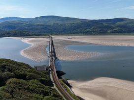 A railway bridge over a river surrounded by mountains at 5 Porkington Terrace in Barmouth