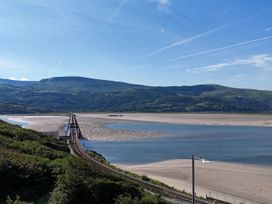A view of a bridge over water with mountains in the background at 5 Porkington Terrace in Barmouth