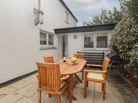 An outdoor area with a dining table and chairs at Wrens Nest in Slapton