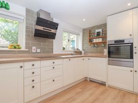 A kitchen with cabinets and appliances at Wrens Nest in Slapton