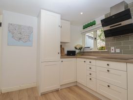 A kitchen with cabinets and a worktop at Wrens Nest in Slapton