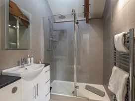 A bathroom with a shower and sink at Wrens Nest in Slapton