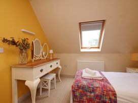 A bedroom with a vanity table and mirror at Scoresby Cottage @ Summerfield Farm in Hawsker
