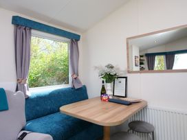 A dining area with a table and stools at Abbey View @ Summerfield Farm in Hawsker