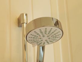 A shower head mounted on the wall at Abbey View @ Summerfield Farm in Hawsker