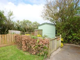 An outdoor area with a shed and wooden fence at Abbey View @ Summerfield Farm in Hawsker