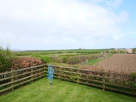 A garden with a clothesline and a view of fields at Abbey View @ Summerfield Farm in Hawsker