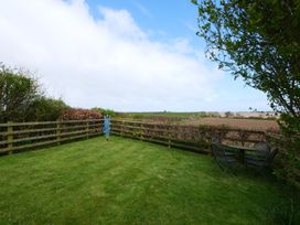 A garden with a table and chairs at Abbey View @ Summerfield Farm, Hawsker