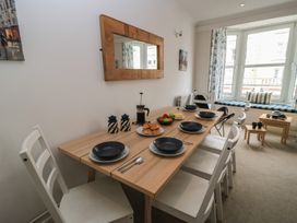 A dining room with a table set for a meal at Still Waters in Swanage