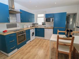 A kitchen with blue cabinets and appliances at Still Waters in Swanage