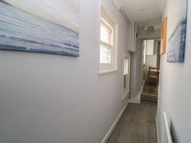 A hallway with a painting and window at Still Waters in Swanage