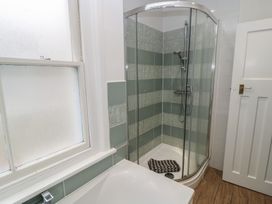 A bathroom with a shower and bathtub at Still Waters in Swanage