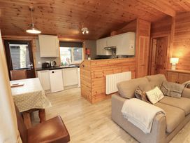 A kitchen with appliances and seating area at The Fold Number 28, Burnside Park near Keswick