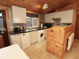 A kitchen with appliances and cabinets at The Fold Number 28, Burnside Park near Keswick