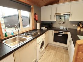 A kitchen with sink and washing machine at The Fold Number 28, Burnside Park near Keswick